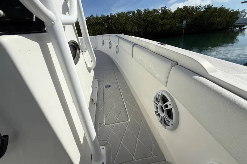 Slide: The Image of 2001 Palmetto Custom 36 boat deck with railing and speaker, near water and trees. - 18