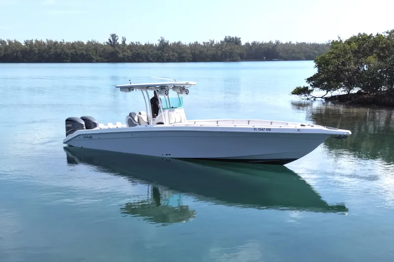 Slide: The Image of 2001 Palmetto Custom 36 boat on calm water, featuring dual outboard motors. - 2