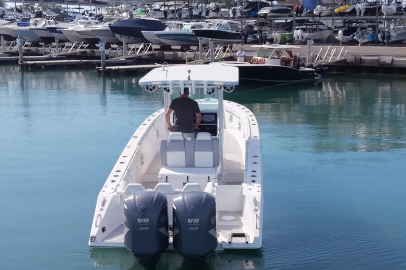 Slide: The Image of 2001 Palmetto Custom 36 boat with dual V8 engines in a marina setting. - 7