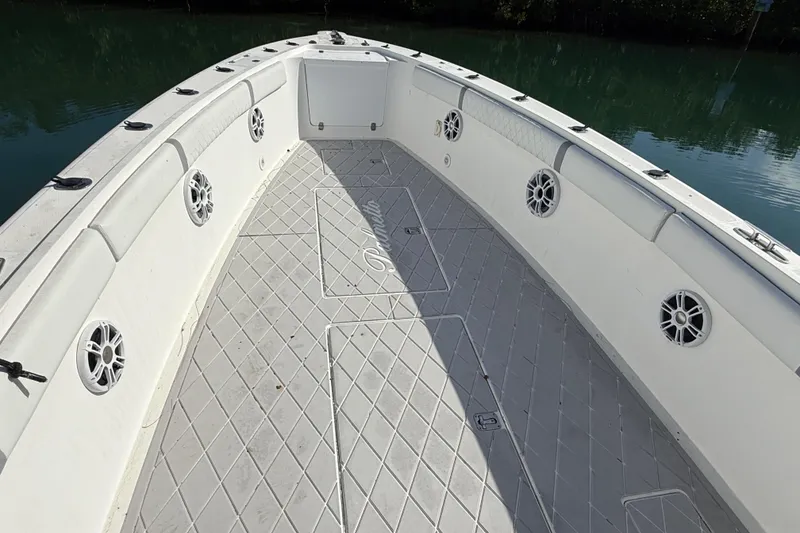 Slide: The Image of 2001 Palmetto Custom 36 boat deck with speakers, docked on calm water. - 9