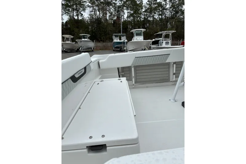 Slide: The Image of 2026 Blackfin 222 CC boat interior with seating and storage, surrounded by other boats. - 10