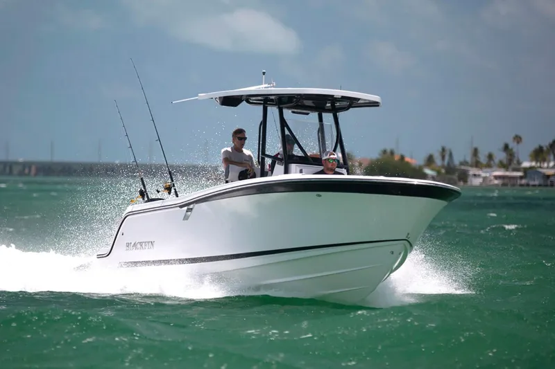 Slide: The Image of Manufacturer Provided Image: 2026 Blackfin 222 CC boat cruising on turquoise water with two passengers. - 12