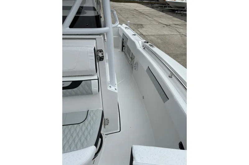 Slide: The Image of 2026 Blackfin 222 CC boat interior with white seating and sleek design. - 16