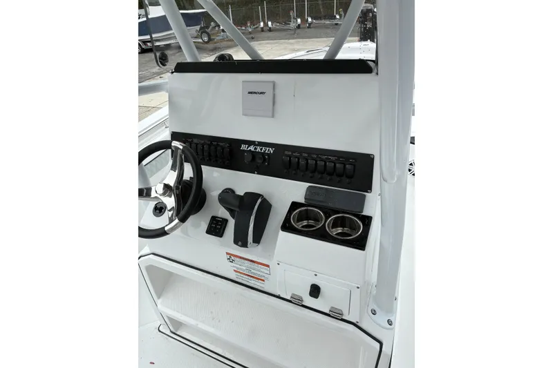 Slide: The Image of 2026 Blackfin 222 CC boat console with steering wheel, controls, and cup holders. - 18