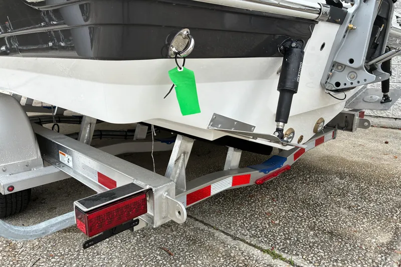 Slide: The Image of 2026 Blackfin 222 CC boat on trailer, rear view with green tag. - 5