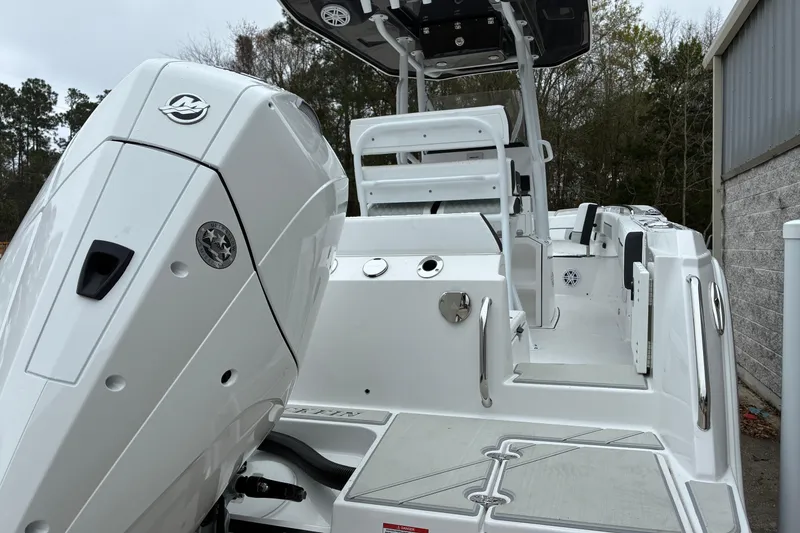 Slide: The Image of 2026 Blackfin 222 CC boat with sleek design and powerful engine, docked outdoors. - 8