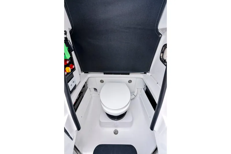 Slide: The Image of Manufacturer Provided Image: 2026 Blackfin 252 CC boat interior with compact marine toilet. - 11