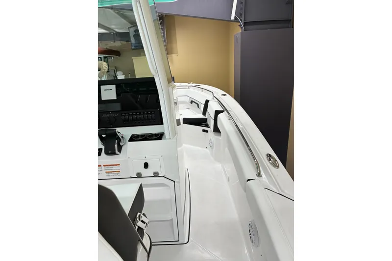 Slide: The Image of 2026 Blackfin 252 CC boat interior with sleek white design and modern controls. - 19