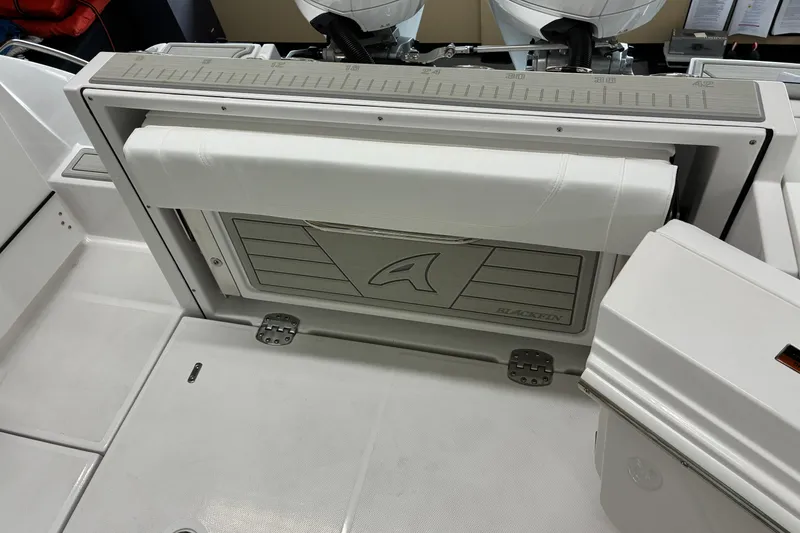 Slide: The Image of 2026 Blackfin 252 CC boat interior with foldable seat and storage compartment. - 22