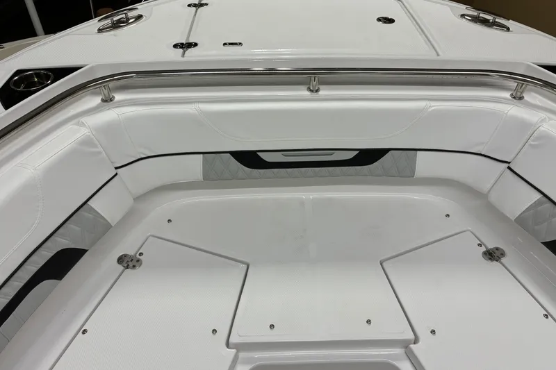 Slide: The Image of 2026 Blackfin 252 CC boat interior with white cushioned seating and storage compartments. - 27