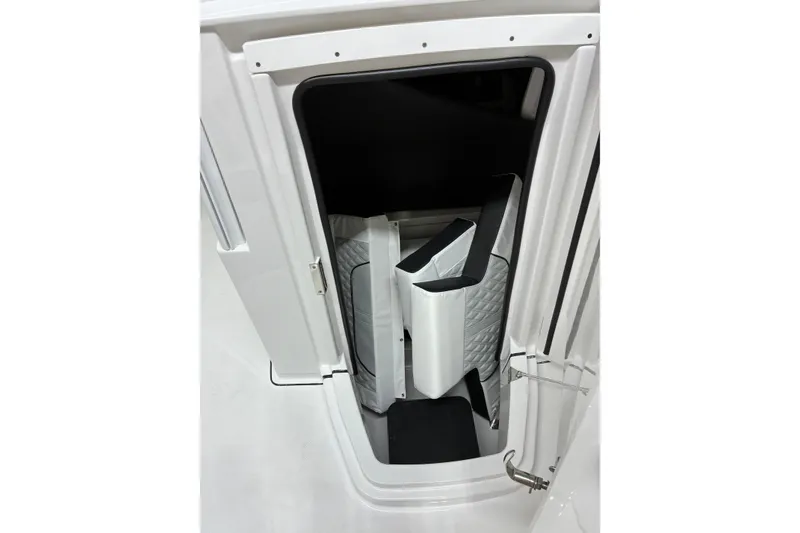 Slide: The Image of 2026 Blackfin 252 CC boat storage compartment with quilted interior detail. - 31