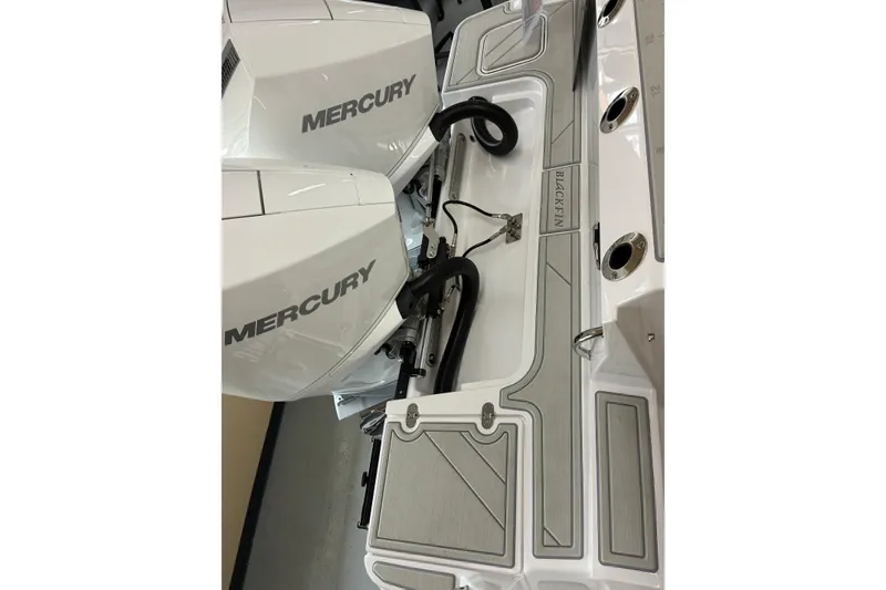 Slide: The Image of 2026 Blackfin 252 CC boat with dual Mercury engines, showcasing sleek design and functionality. - 32
