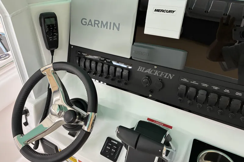 Slide: The Image of 2026 Blackfin 252 CC boat dashboard with Garmin and Mercury controls. - 8