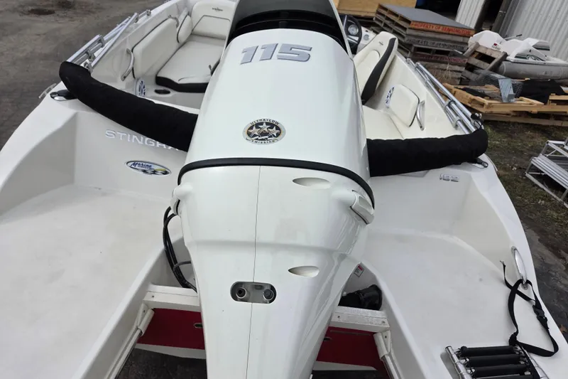 Slide: The Image of 2020 Stingray 182 SC boat with powerful outboard motor, white interior, and sleek design. - 10
