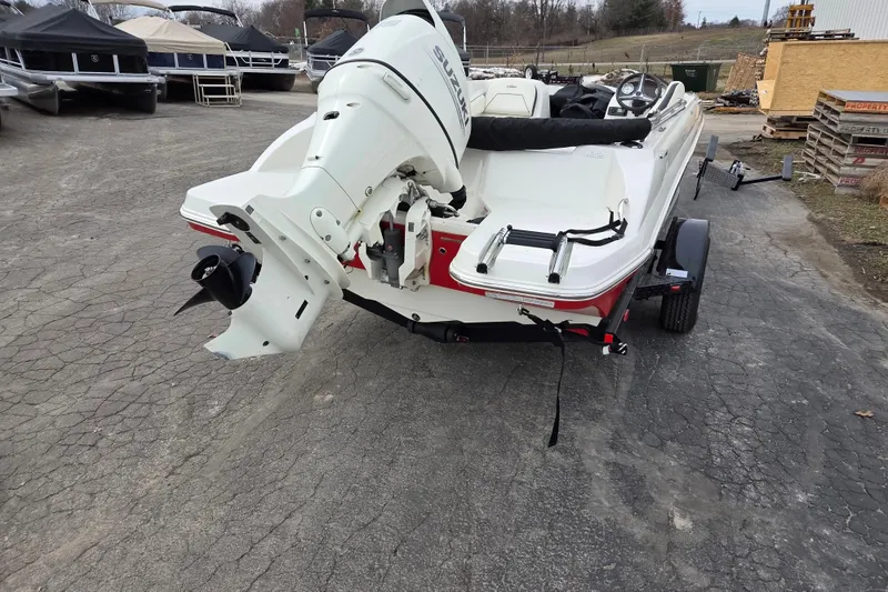 Slide: The Image of 2020 Stingray 182 SC boat with outboard motor on trailer, parked outdoors. - 11