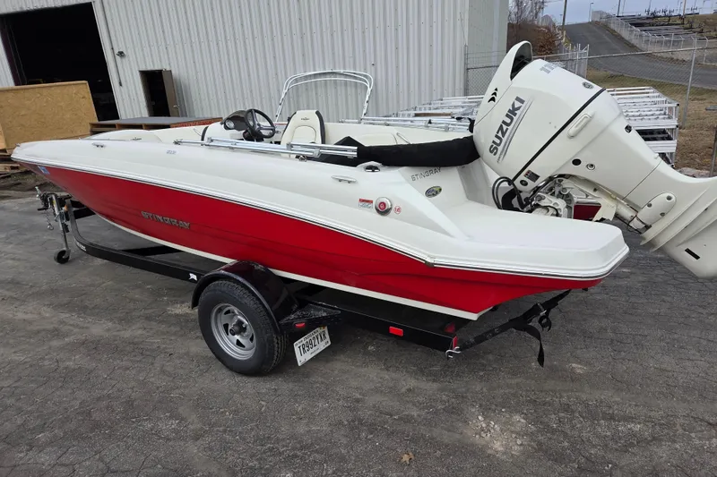 Slide: The Image of 2020 Stingray 182 SC boat with Suzuki outboard motor on trailer. - 2
