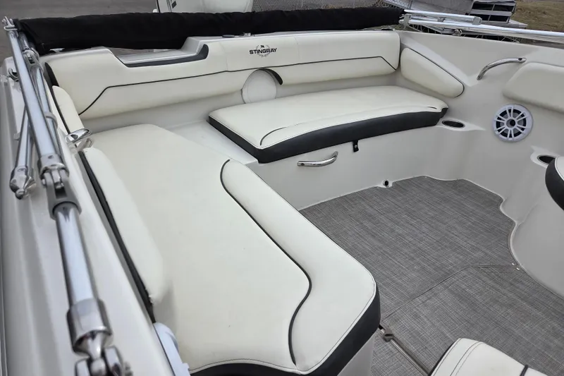 Slide: The Image of 2020 Stingray 182 SC boat interior with white seating and gray flooring. - 7