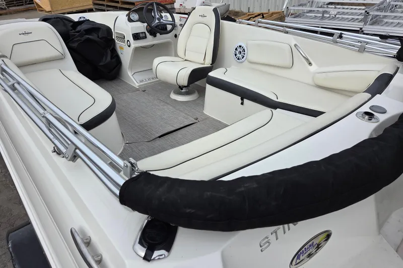 Slide: The Image of 2020 Stingray 182 SC boat interior with white seating and steering console. - 8