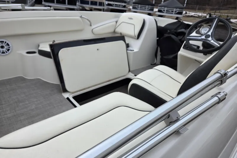 Slide: The Image of 2020 Stingray 182 SC boat interior with white seating and steering wheel. - 9