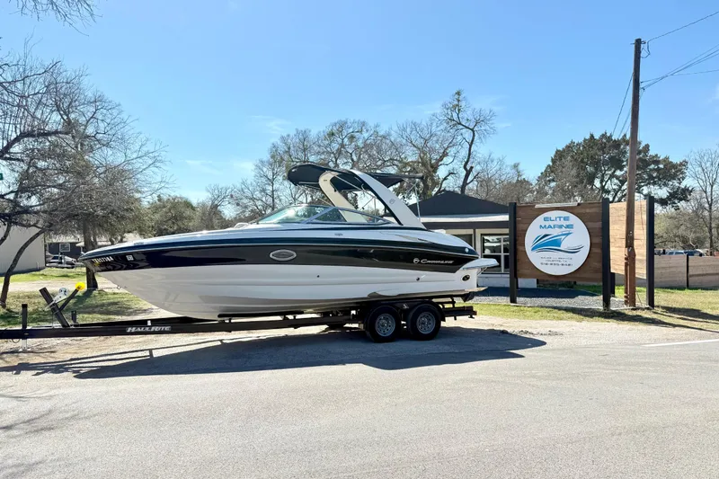 The Image of 2008 Crownline 260 LS boat on trailer at Elite Marine dealership. - 1