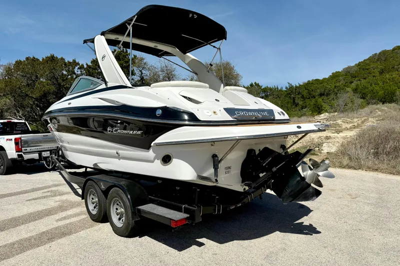 Slide: The Image of 2008 Crownline 260 LS boat on trailer, parked outdoors on a sunny day. - 11