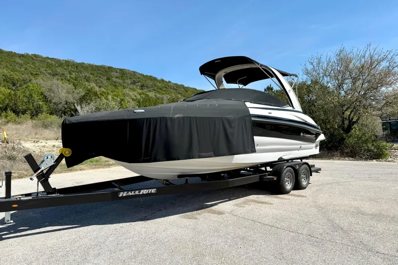 Slide: The Image of 2008 Crownline 260 LS boat on trailer, covered, parked outdoors. - 15