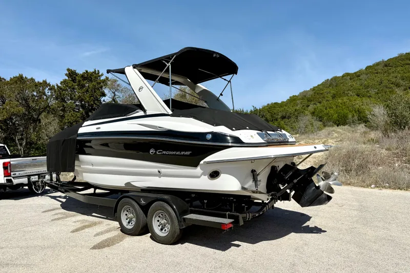 Slide: The Image of 2008 Crownline 260 LS boat on trailer, parked outdoors under clear sky. - 16