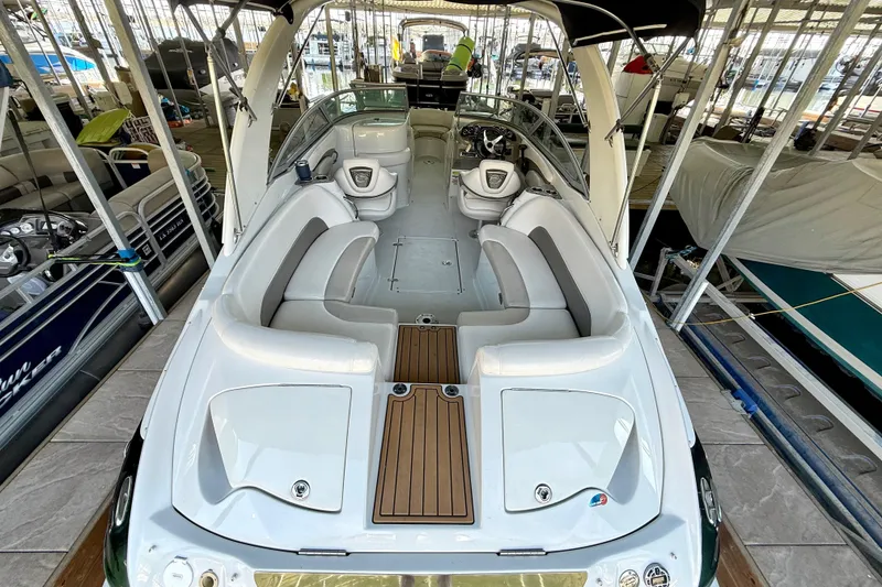 Slide: The Image of 2008 Crownline 260 LS boat interior with seating, docked in a marina. - 18