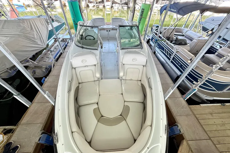 Slide: The Image of 2008 Crownline 260 LS boat docked, featuring spacious seating and sleek design. - 21