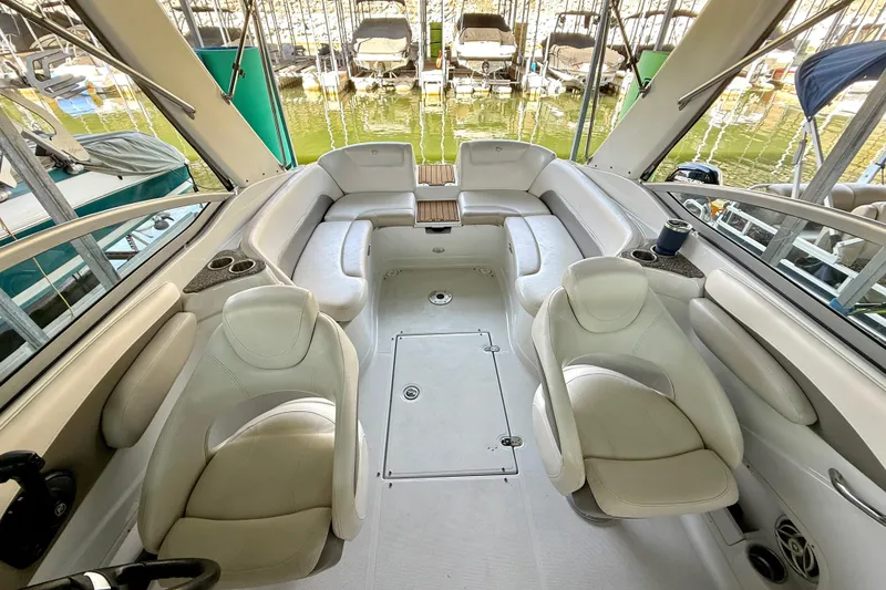 Slide: The Image of 2008 Crownline 260 LS boat interior with white seating and cup holders. - 22