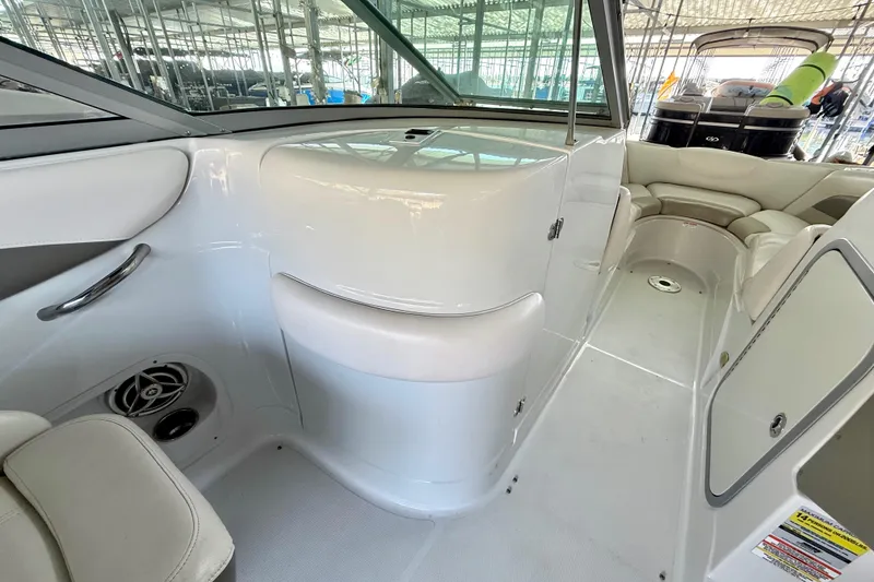 Slide: The Image of 2008 Crownline 260 LS boat interior with seating and storage compartments. - 25