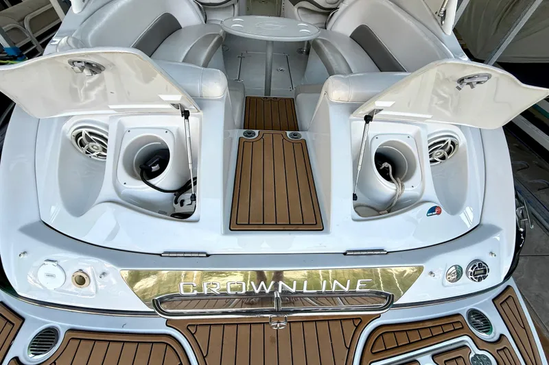 Slide: The Image of 2008 Crownline 260 LS boat interior with open storage compartments and seating. - 26