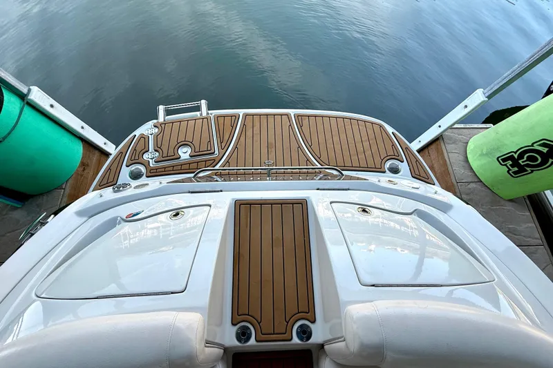 Slide: The Image of 2008 Crownline 260 LS boat with teak deck, docked by calm water. - 27