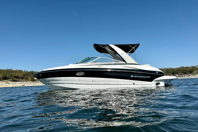 Slide: The Image of 2008 Crownline 260 LS boat on water under clear blue sky. - 3