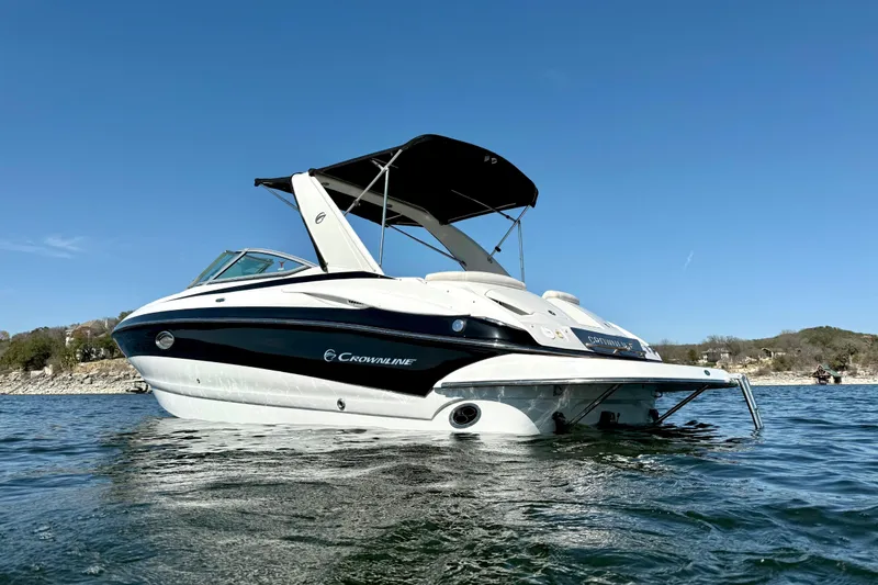Slide: The Image of 2008 Crownline 260 LS boat on water, clear sky background. - 4