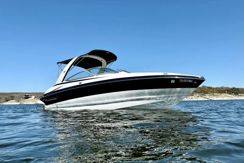 Slide: The Image of 2008 Crownline 260 LS boat on water under clear blue sky. - 6