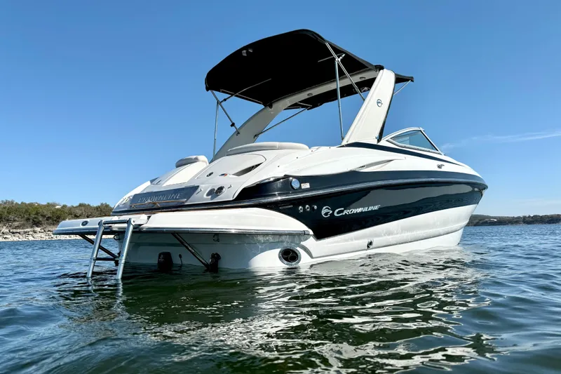 Slide: The Image of 2008 Crownline 260 LS boat on water, featuring sleek design and black accents. - 8