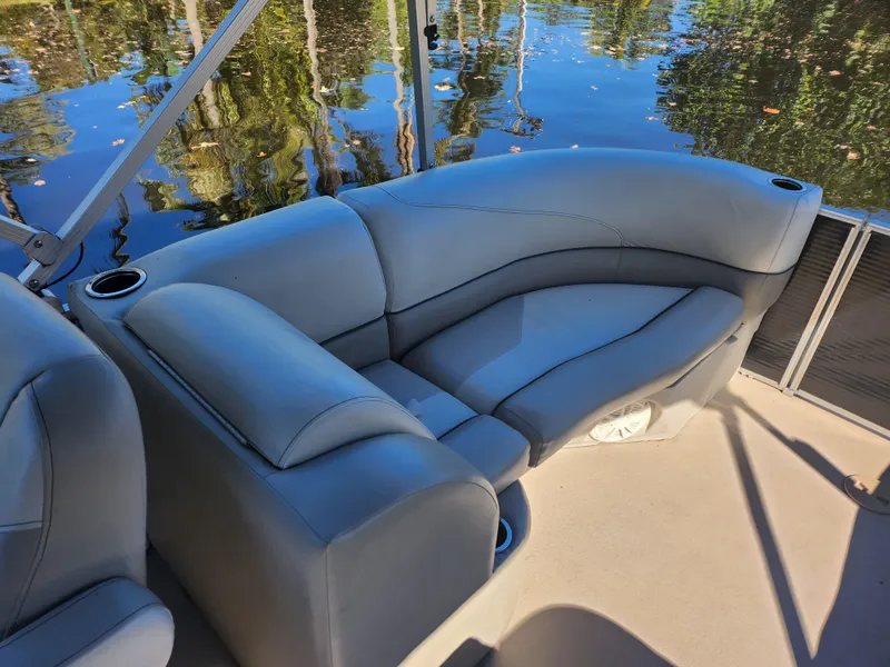 Slide: The Image of 2020 Cypress Cay Seabreeze 232 boat interior with plush seating and cup holder. - 10