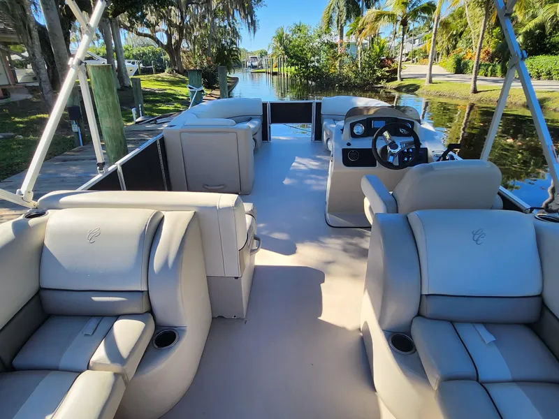 Slide: The Image of 2020 Cypress Cay Seabreeze 232 boat interior with steering wheel and plush seating. - 14