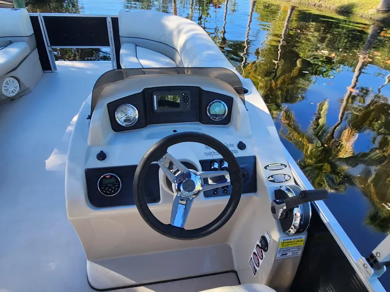 Slide: The Image of 2020 Cypress Cay Seabreeze 232 pontoon boat on calm water with canopy. - 15