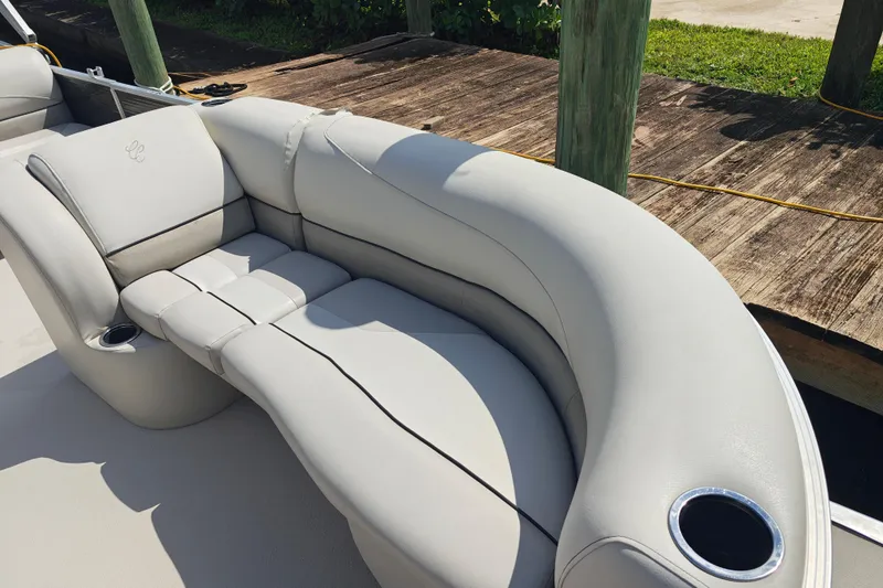 Slide: The Image of Luxurious seating on 2020 Cypress Cay Seabreeze 232 pontoon boat, docked by wooden pier. - 22