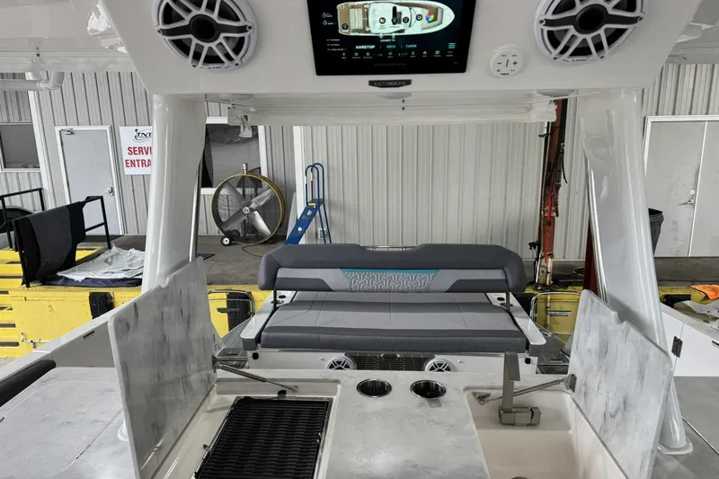 Slide: The Image of 2026 Regal 38 Surf boat interior with grill, sink, and seating in a service area. - 13