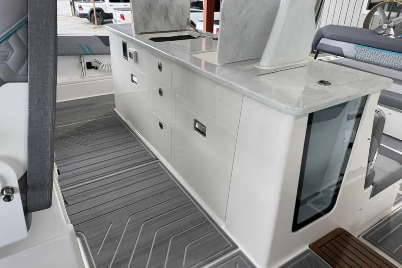 Slide: The Image of 2026 Regal 38 Surf boat interior with sleek cabinetry and modern design. - 14
