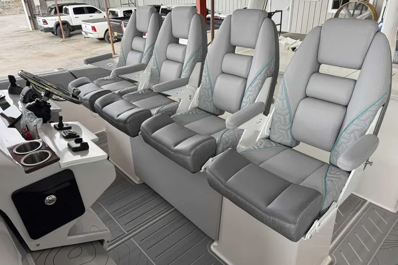 Slide: The Image of Luxurious seating on the 2026 Regal 38 Surf boat, featuring modern helm controls. - 15