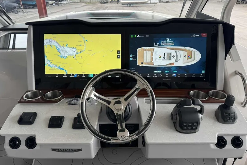 Slide: The Image of 2026 Regal 38 Surf boat dashboard with dual Garmin displays and modern controls. - 17
