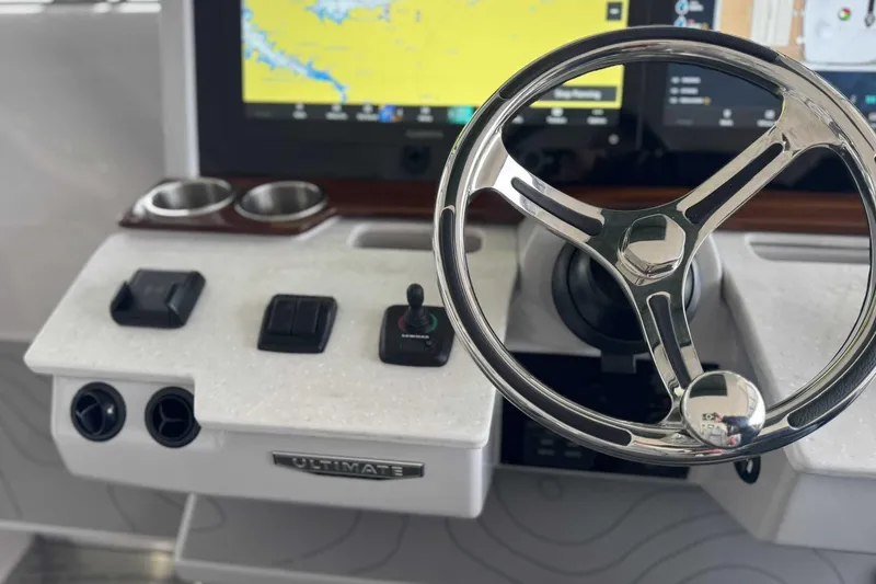 Slide: The Image of 2026 Regal 38 Surf boat dashboard with steering wheel and navigation display. - 21