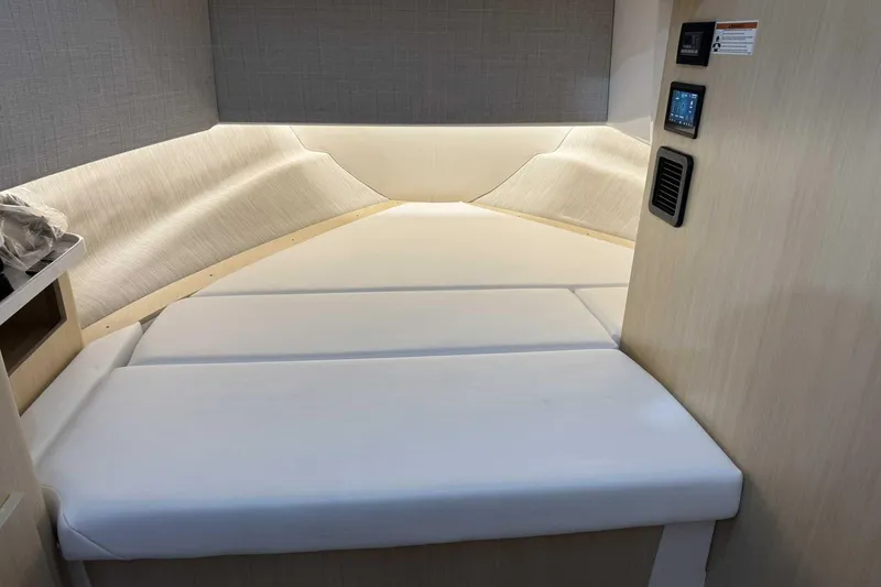 Slide: The Image of 2026 Regal 38 Surf cabin interior with modern bedding and control panel. - 28