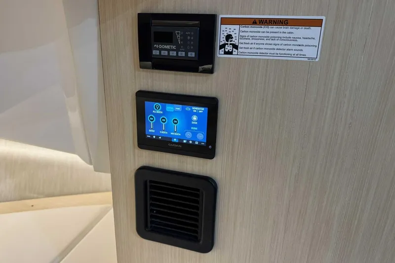 Slide: The Image of Control panel and warning label inside 2026 Regal 38 Surf boat cabin. - 29