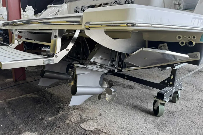 Slide: The Image of 2026 Regal 38 Surf boat with dual propellers and swim platform in a storage area. - 5