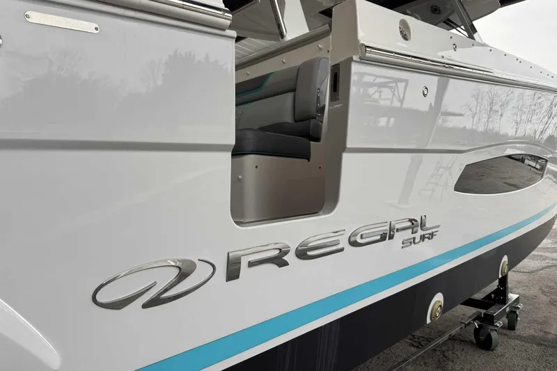 Slide: The Image of 2026 Regal 38 Surf boat side view with logo and sleek design. - 6